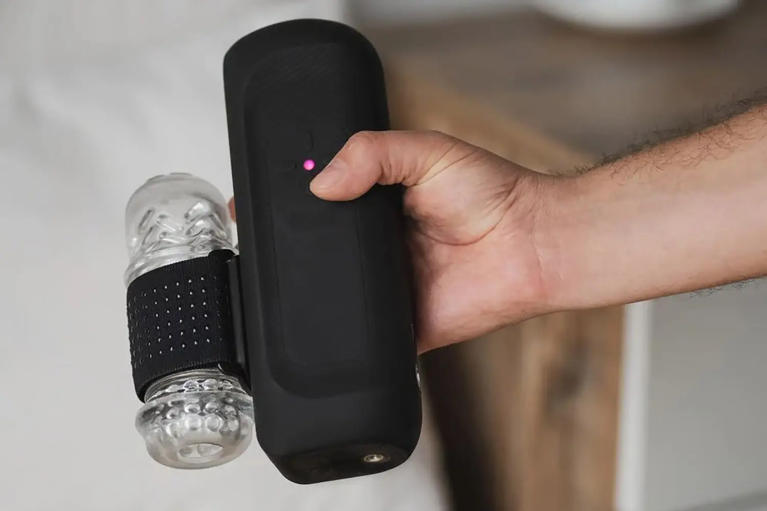 The Handy 2 held in one hand during a cordless session with clear textured sleeve mounted and status LED lit