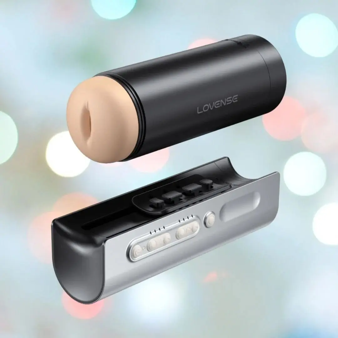 Lovense Solace Pro taken apart: the removable stroker cup with its sleeve lifted off the silver base for cleaning